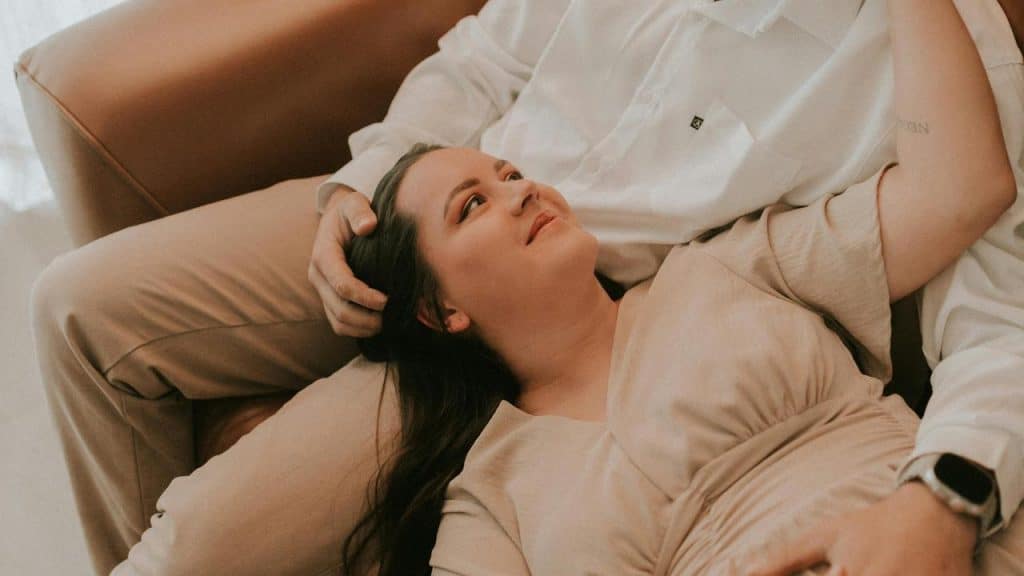 A woman resting her head on a man’s lap