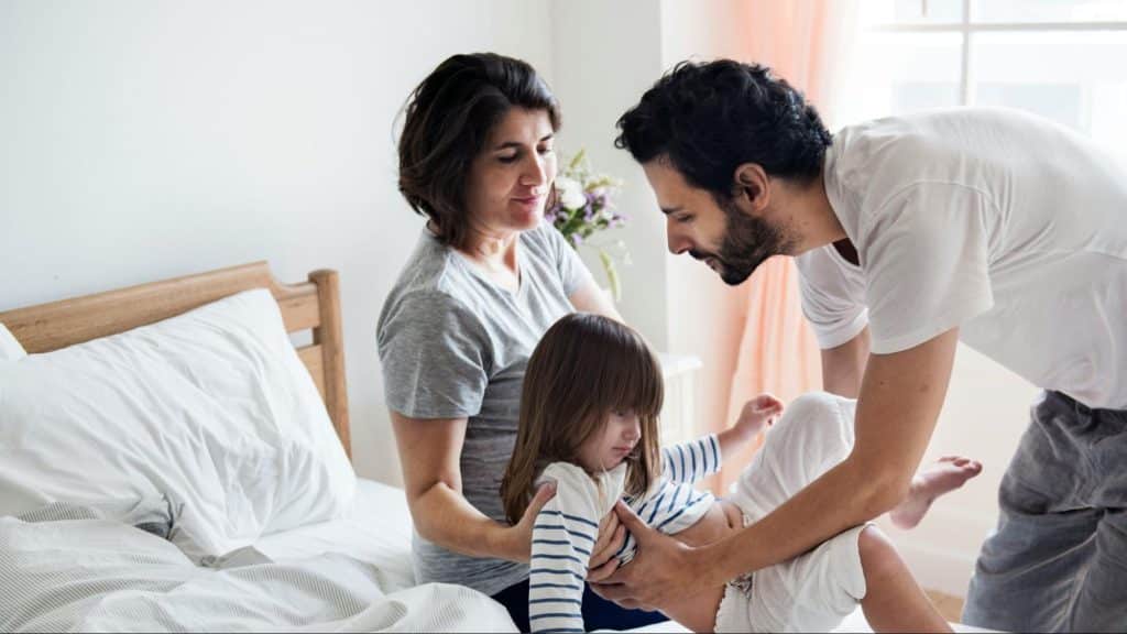 A man getting the child from a woman