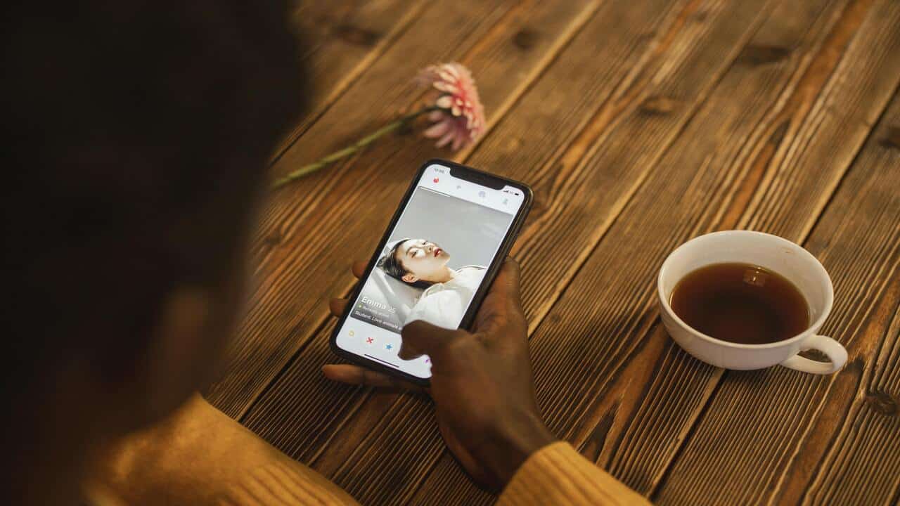 A man looking at a dating app