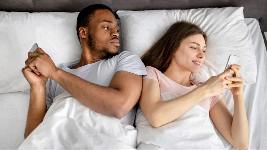 A man checking woman’s phone activities