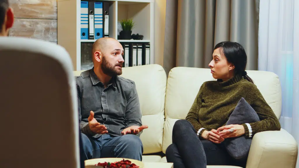 Couple having serious conversation on a couch