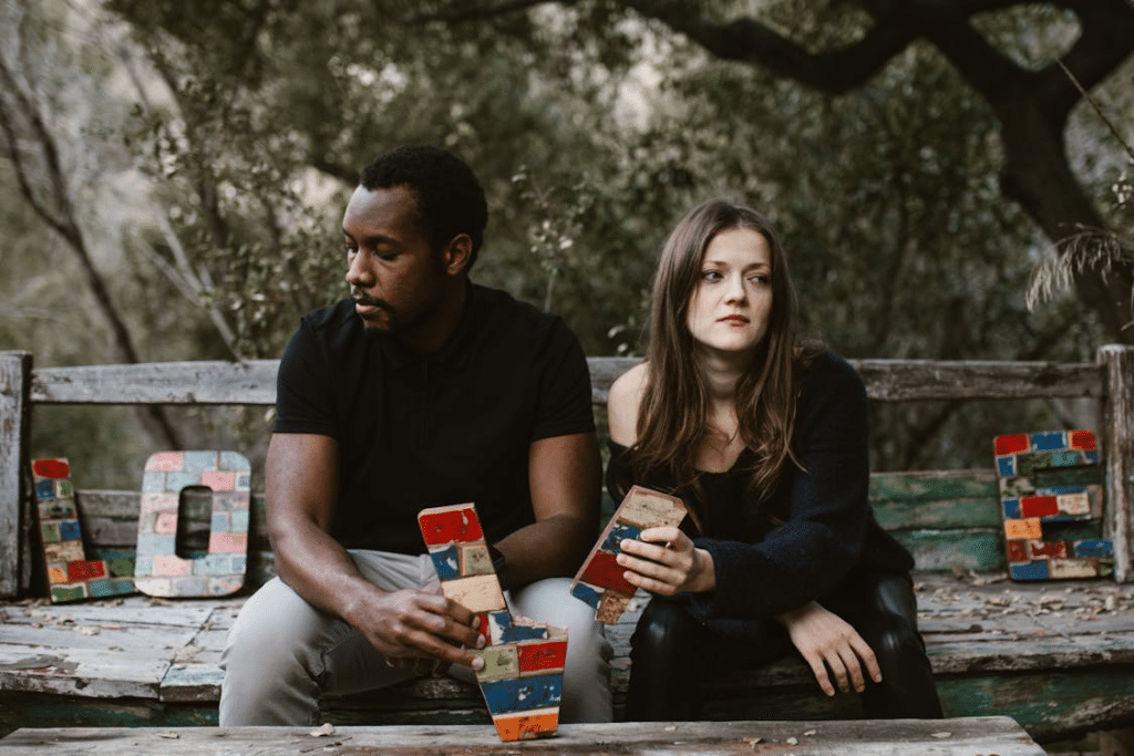 Couple in park ignoring each other