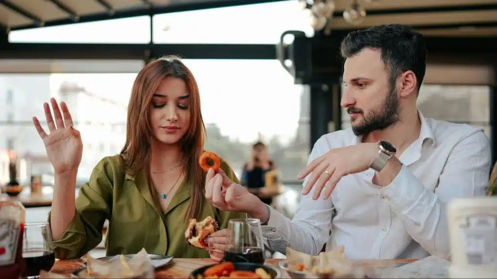 A man forcing woman to get the food