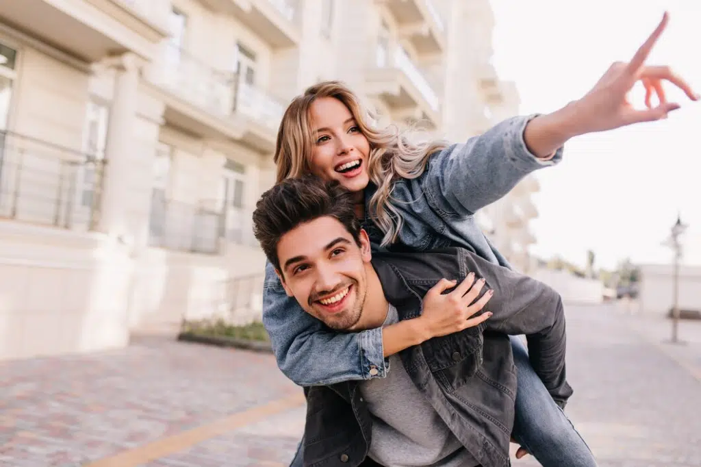 Pretty young couple having fun outside