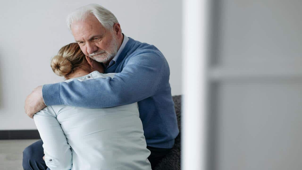 A man consoling his upset wife