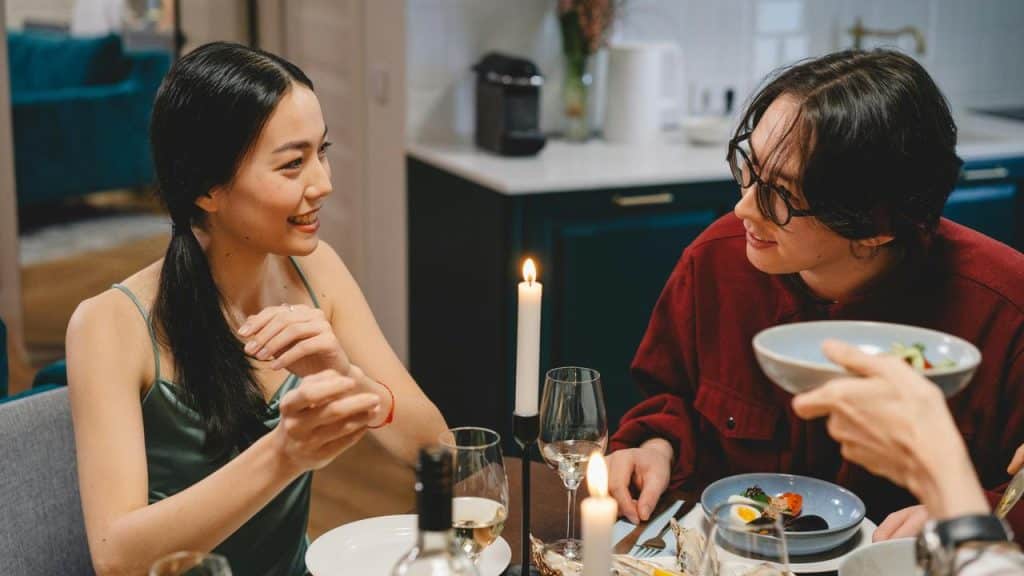 A woman smiling and talking to a man
