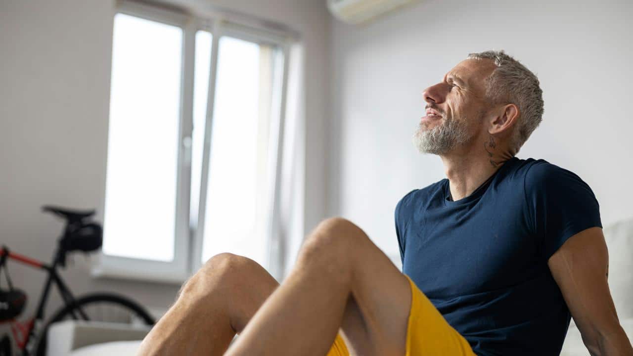 An older man sitting indoors