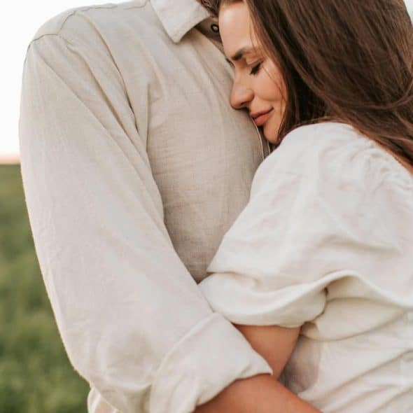 A woman hugging a man