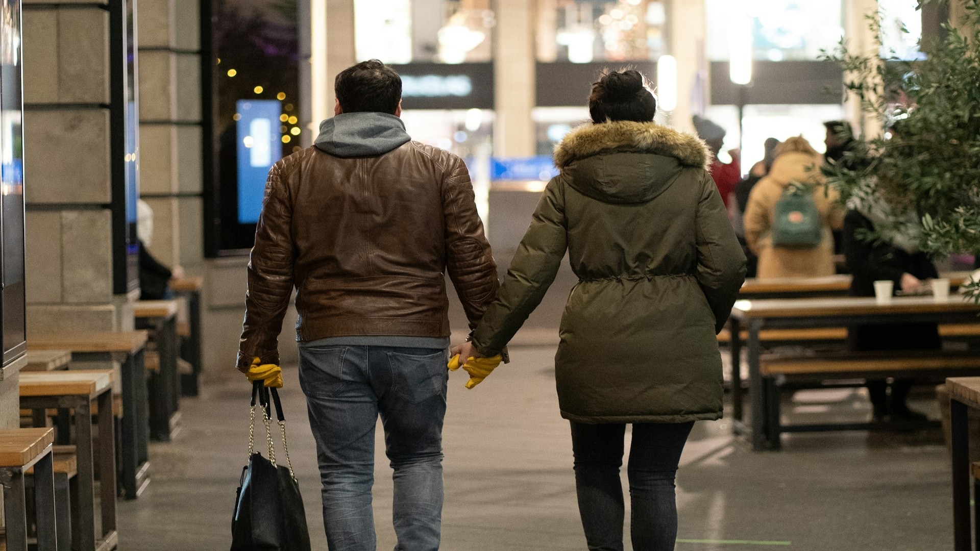man walking beside partner on street