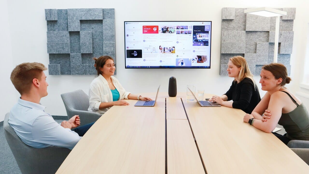 Colleagues speaking at a conference table