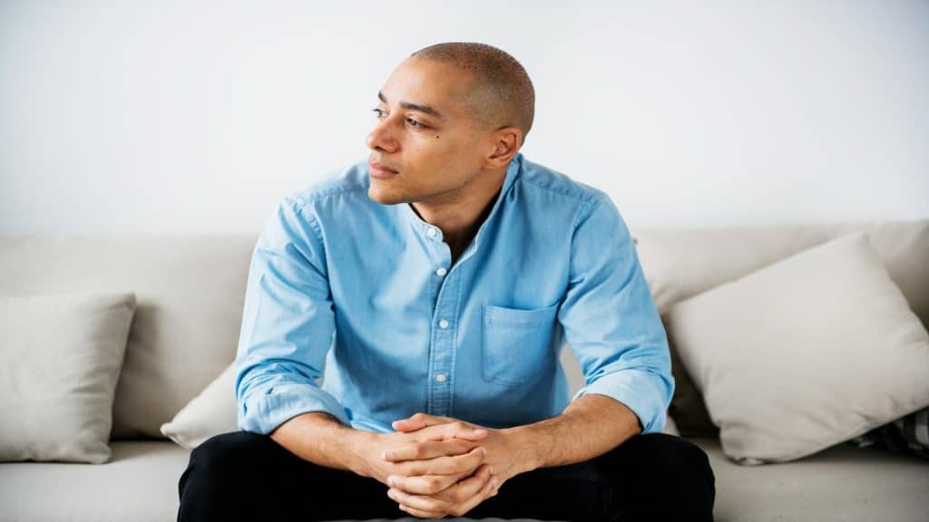 man sitting calmly during conversation