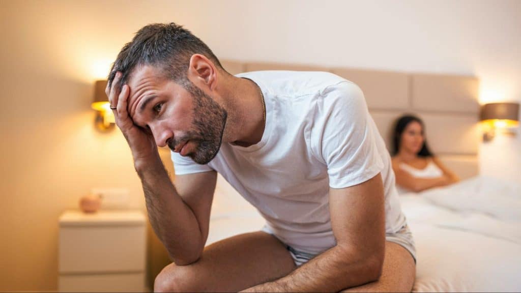 A man thinking and a woman sitting on the bed 