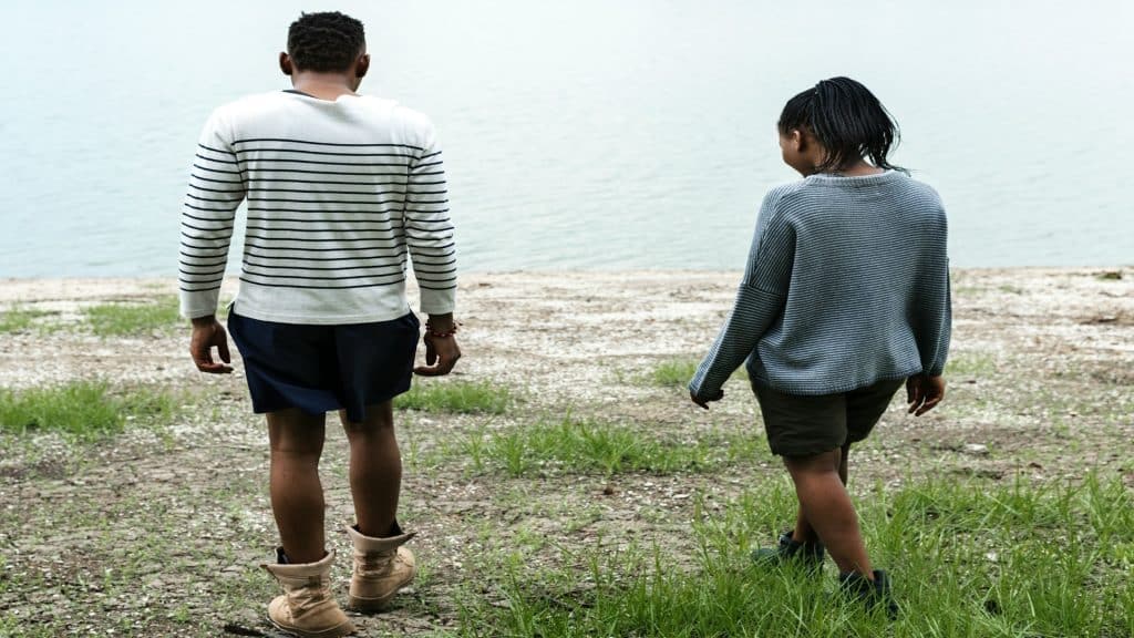 couple walking apart with space between them
