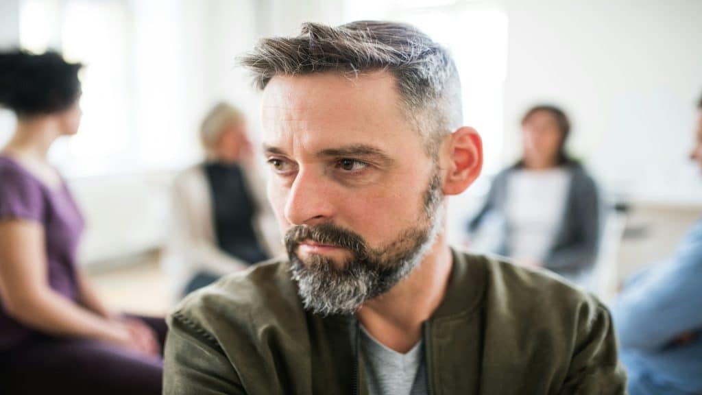 man sitting calmly during discussion