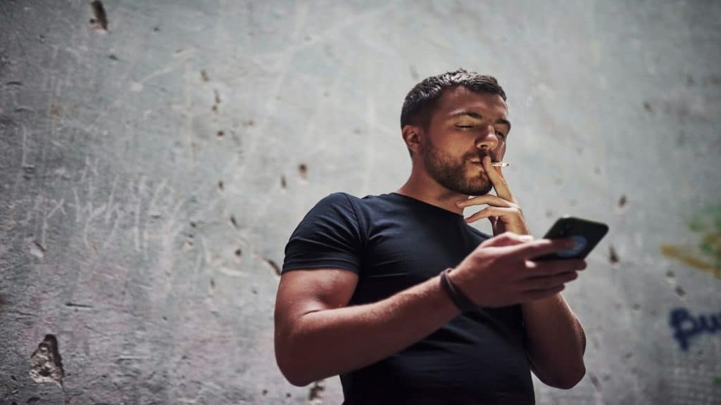 man looking at phone thoughtfully
