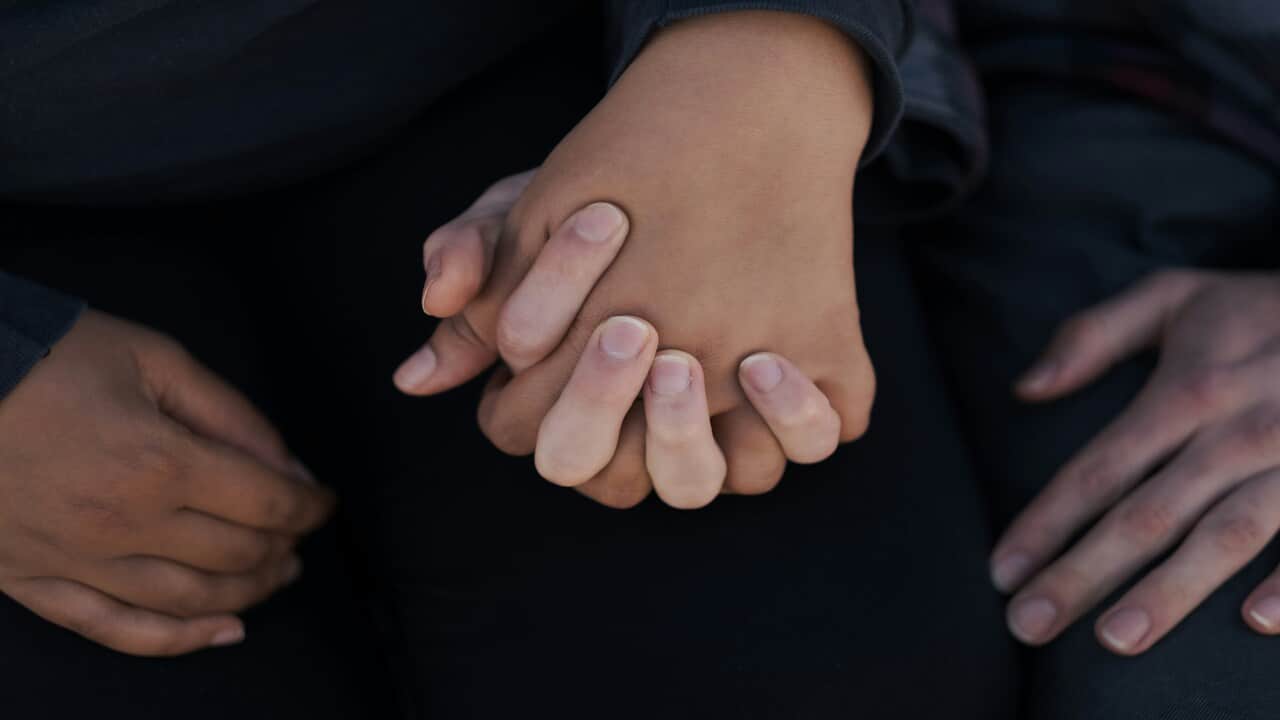 Two people holding hands