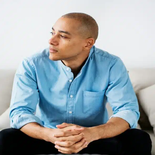 man sitting quietly looking conflicted