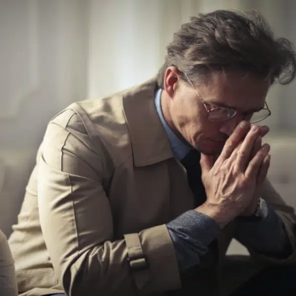 A man looking sad at home