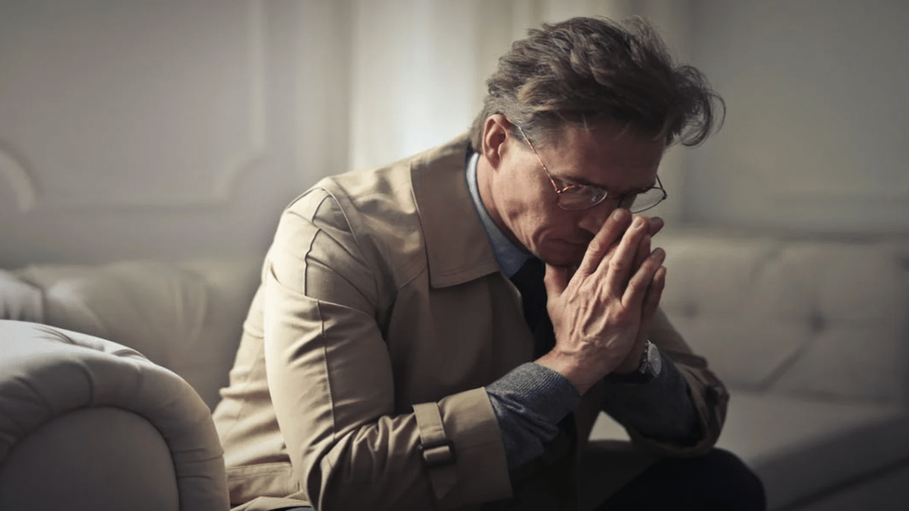 A man looking sad at home