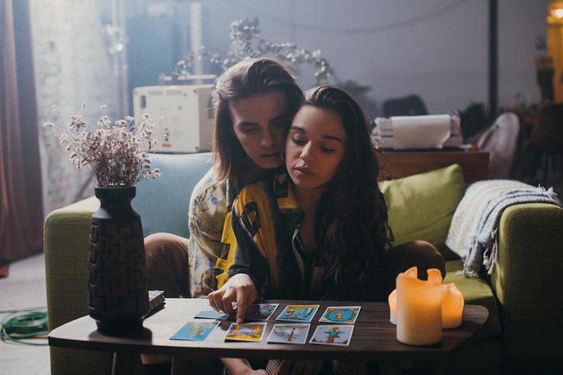 A couple in the living room reading cards