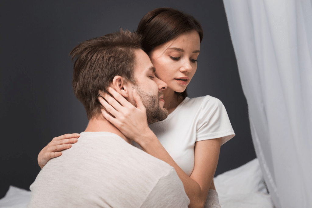 A man cuddling a woman