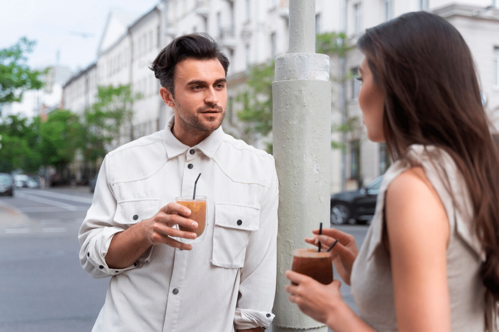 A man and woman having drinks on their hands