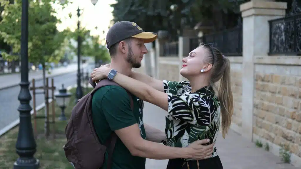 A man standing next to a woman on a sidewalk.