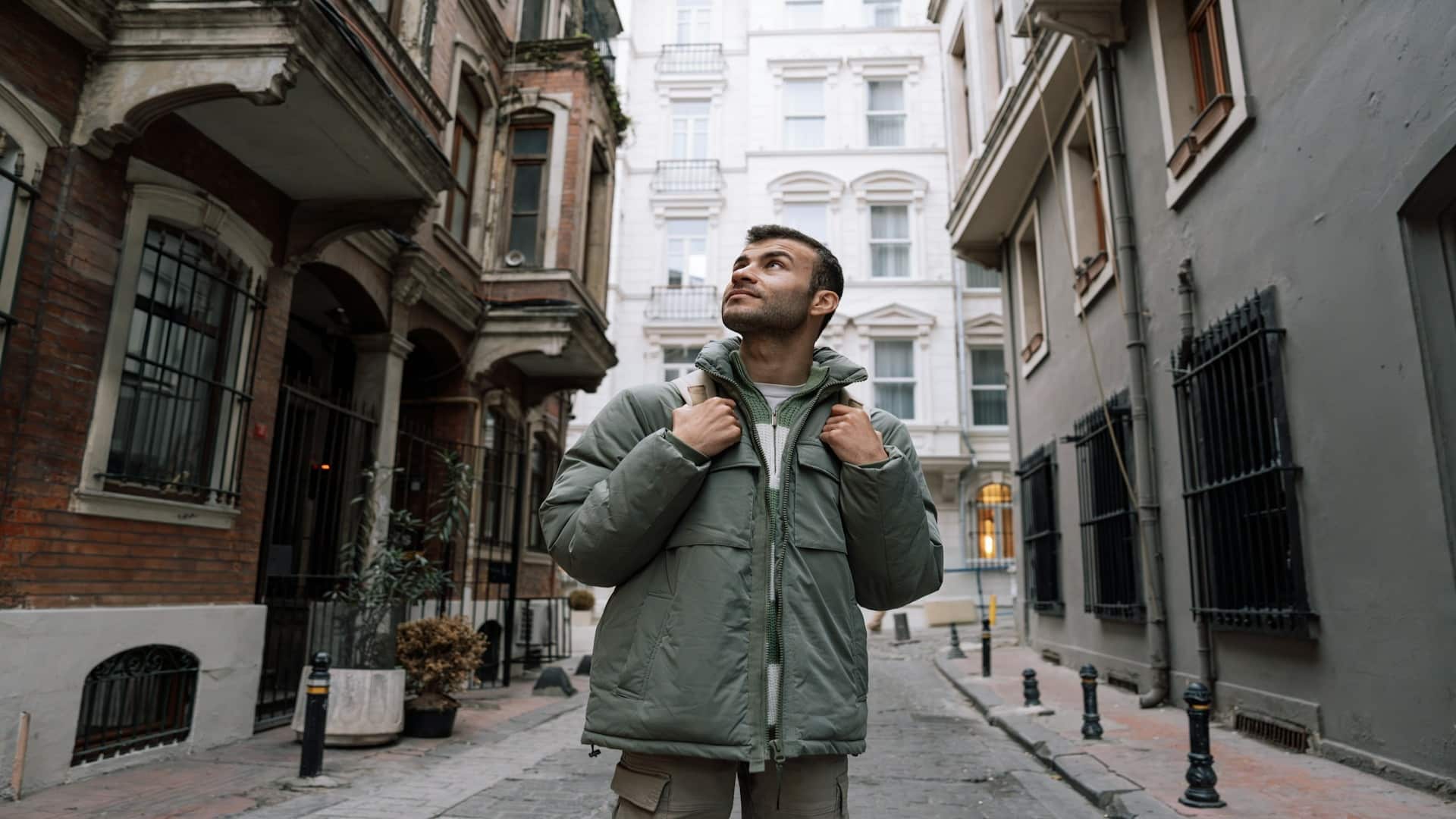 man standing confidently in city