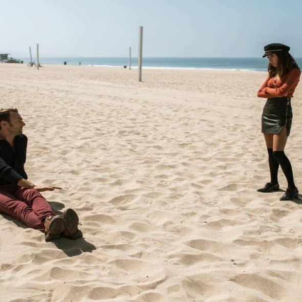 A couple talking on the beach