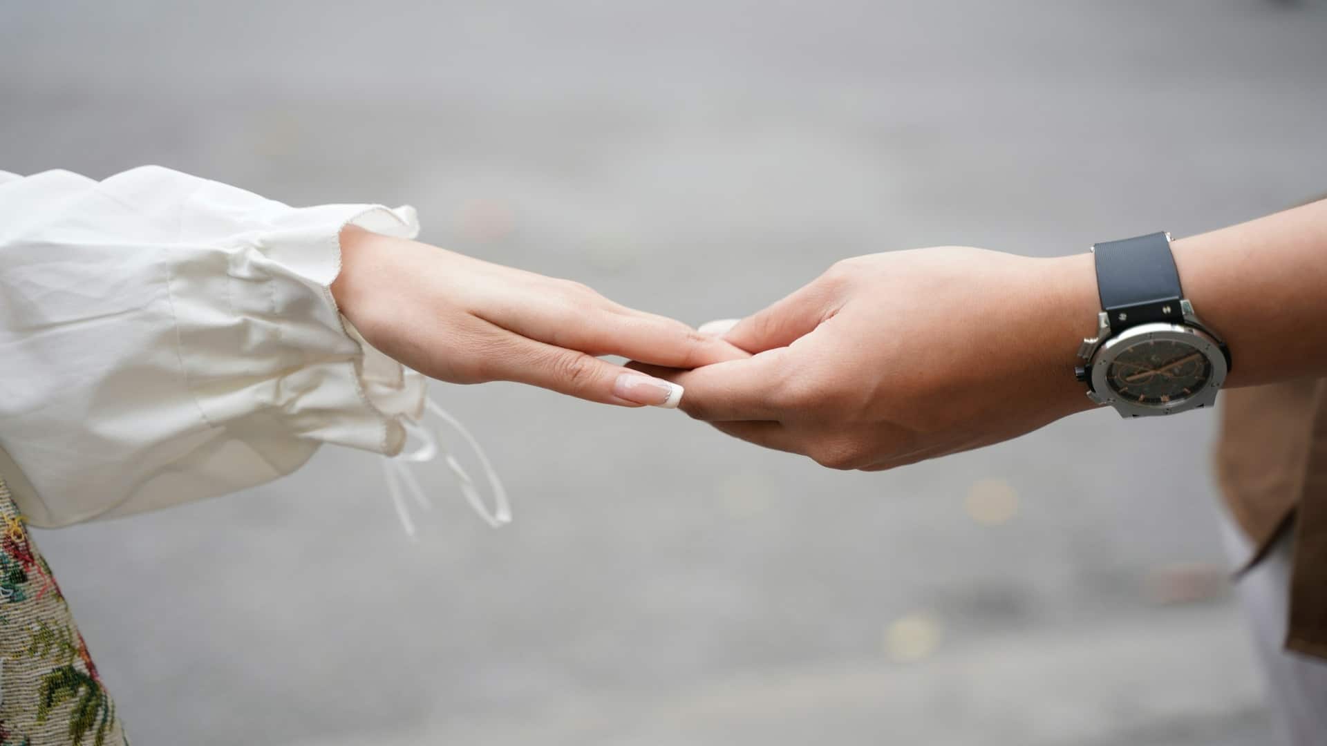 couple holding hands during conversation