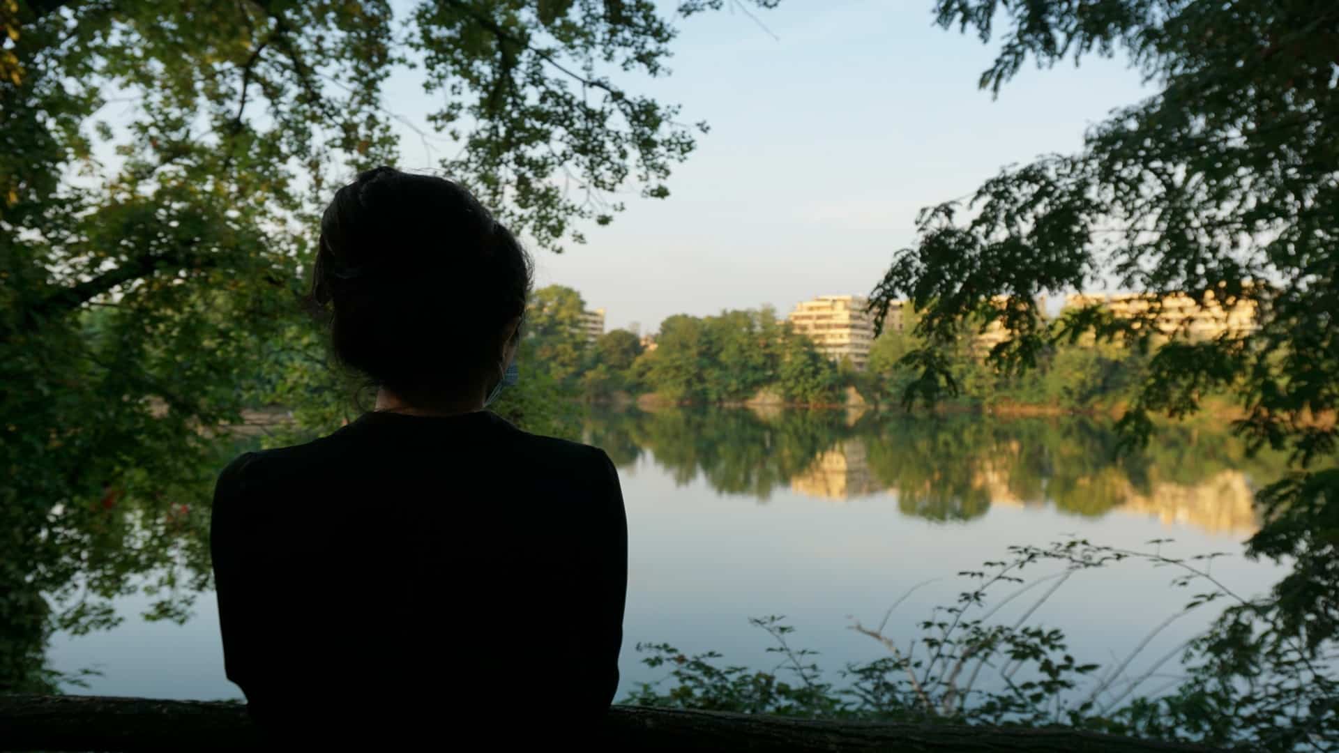 person reflecting calmly outdoors