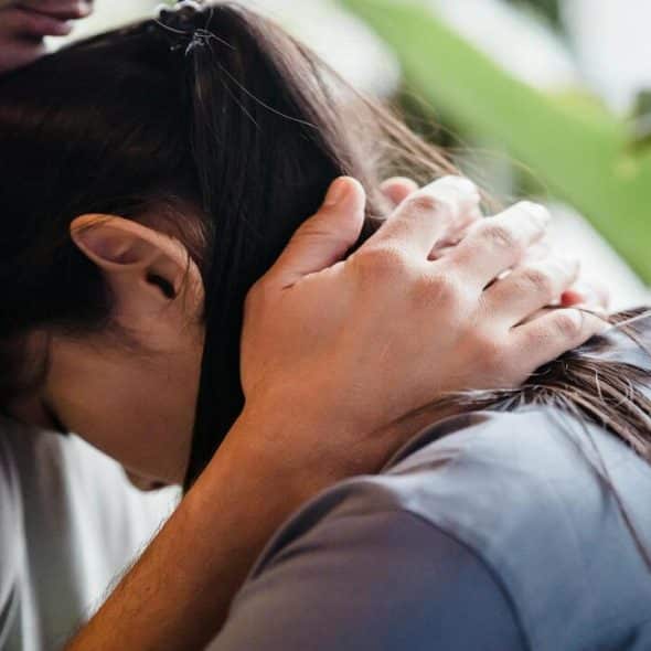 A woman leaning on her husband’s chest