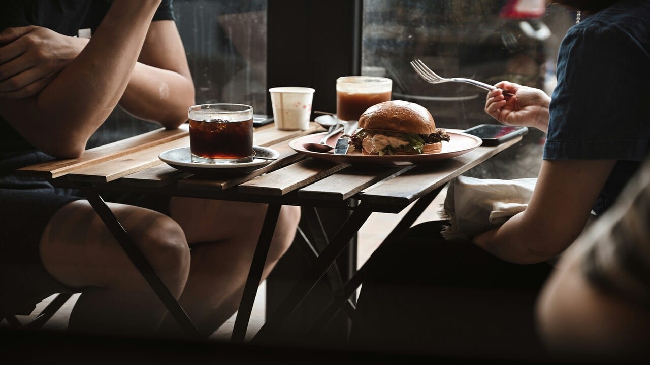 A couple talking over lunch