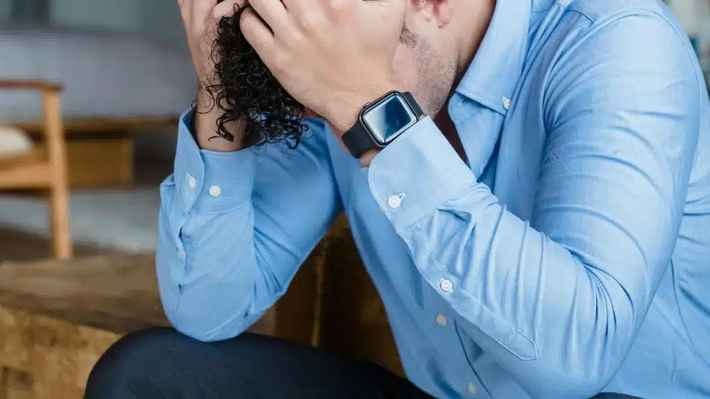 A man holding his head in stress