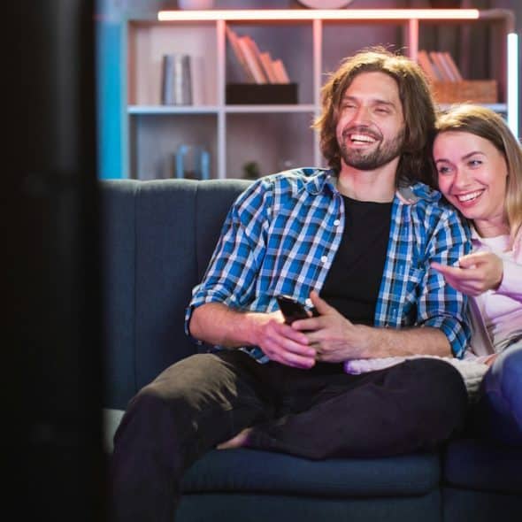 A couple watching movie in happy mood.