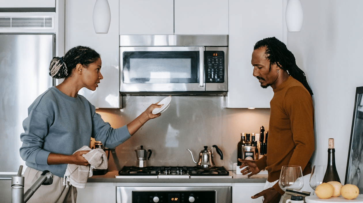 Couple arguing in kitchen at home