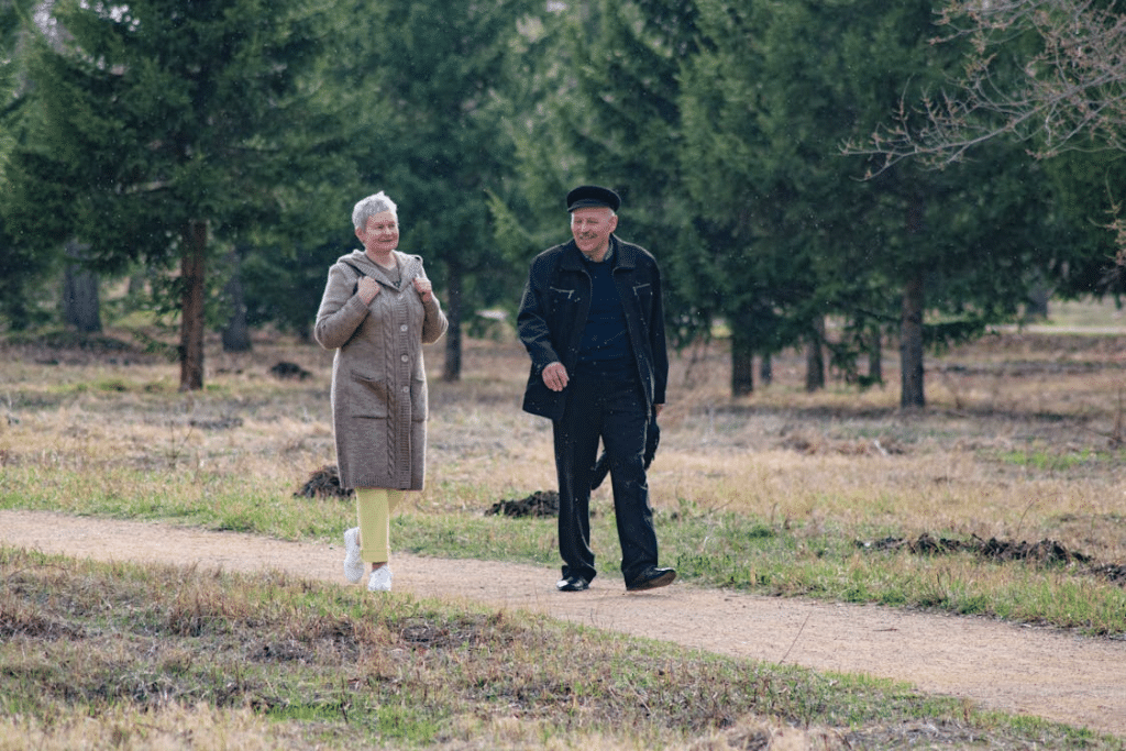 Mature couple walking slowly in park conversation