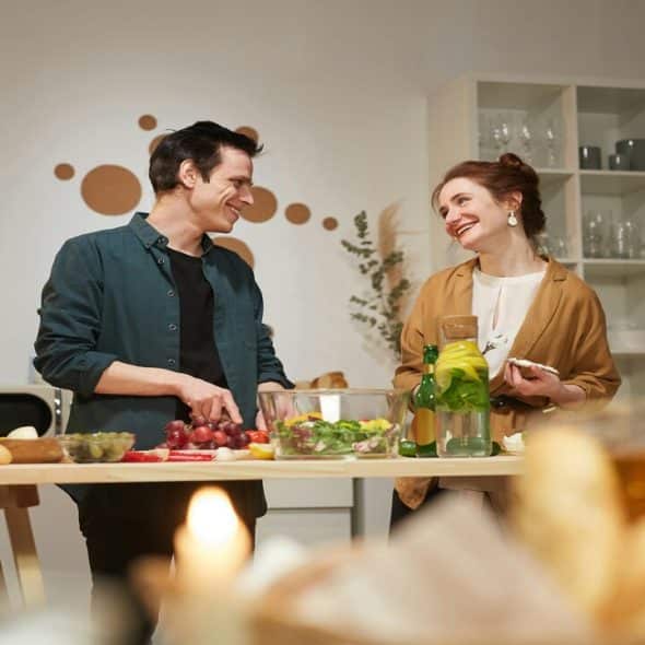 A couple talking in the kitchen