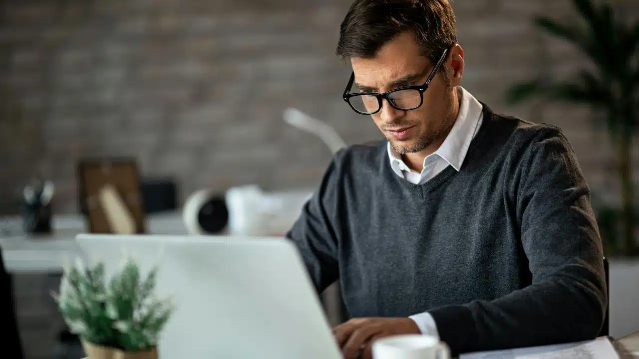 A man in glasses working