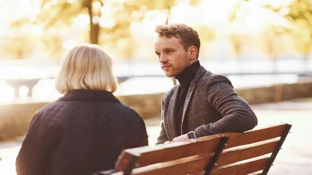 man appearing less involved in conversation