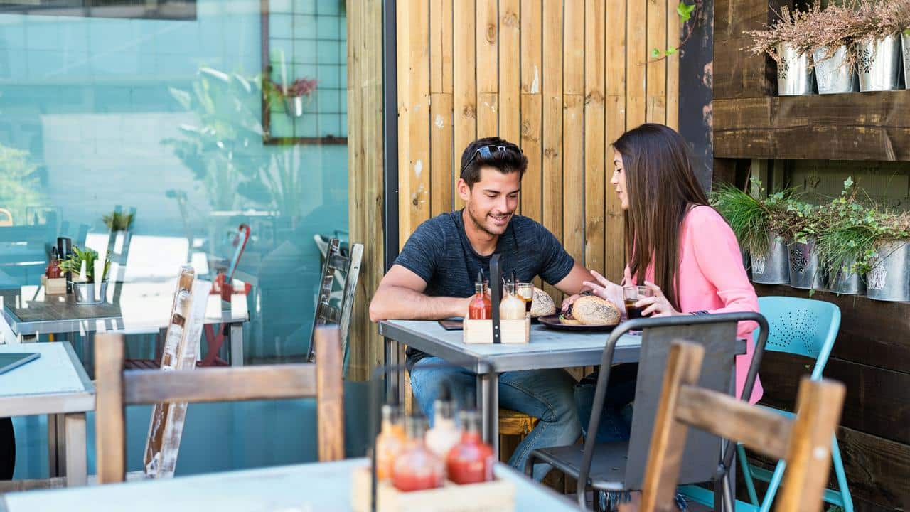 A couple chatting and sharing a meal