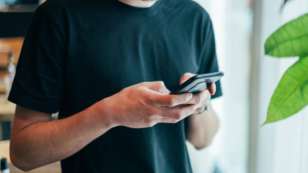 A person using a smartphone indoors.