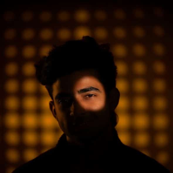 A man has one eye lit.