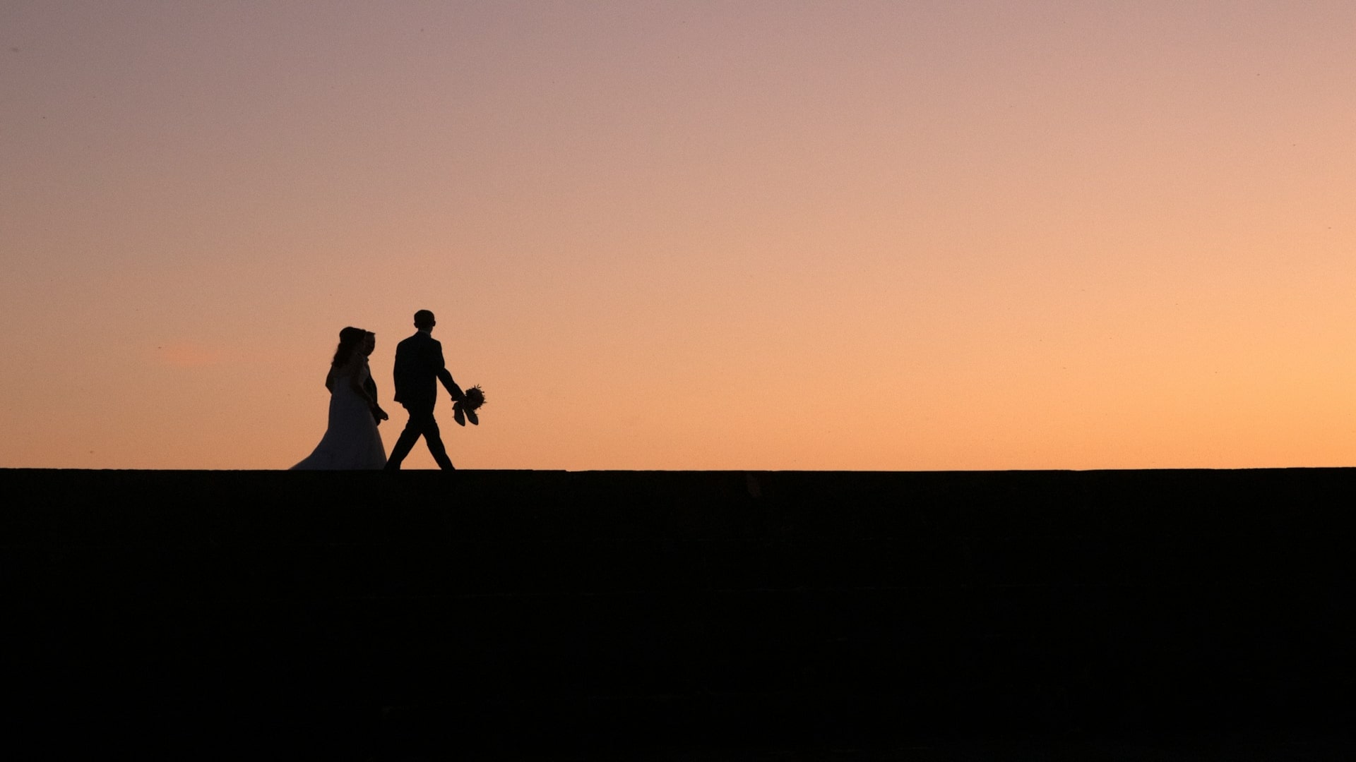 couple walking together at sunset