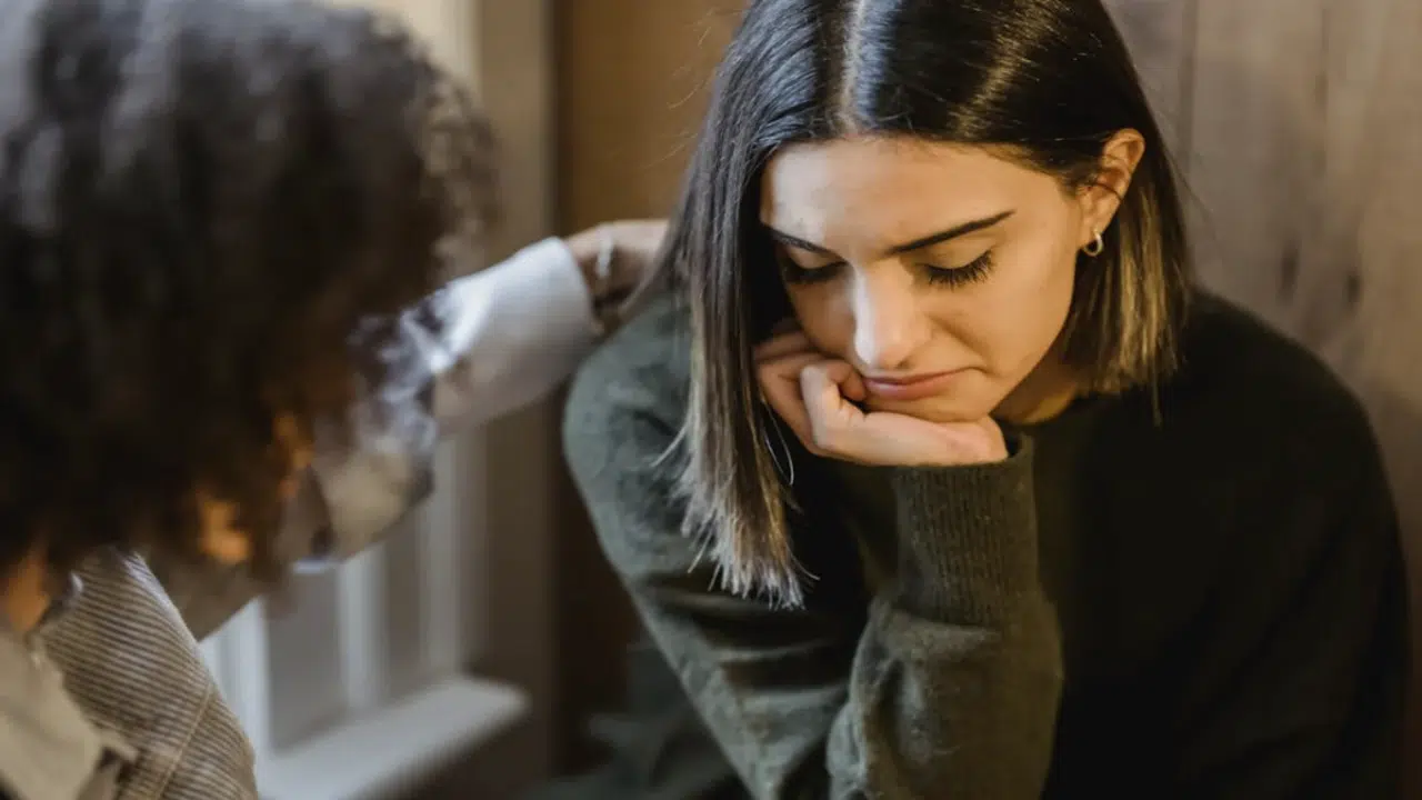 A woman comforting her upset friend