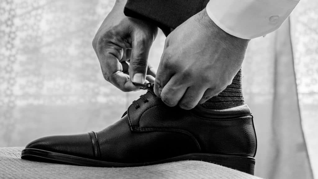 A man tying his shoes laces.