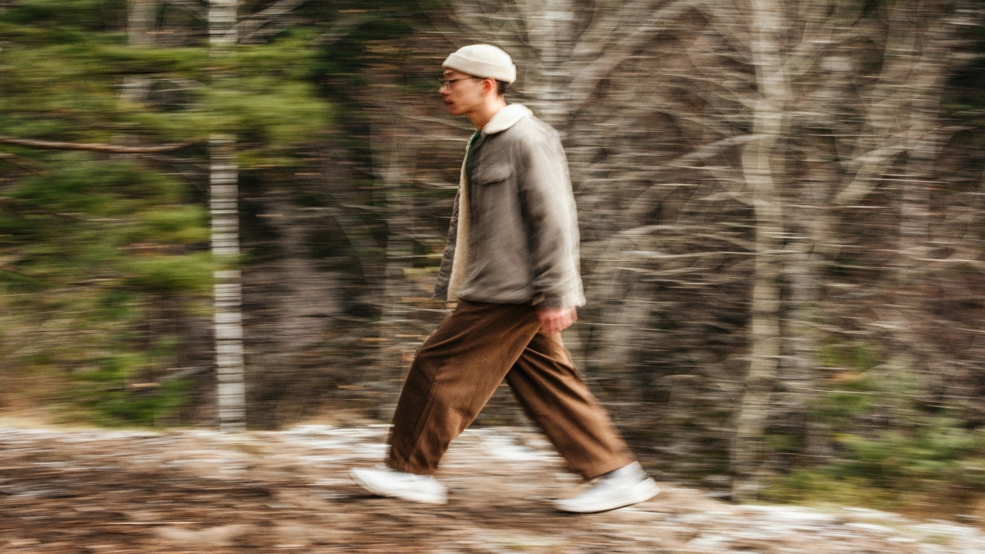 man walking thoughtfully outdoors