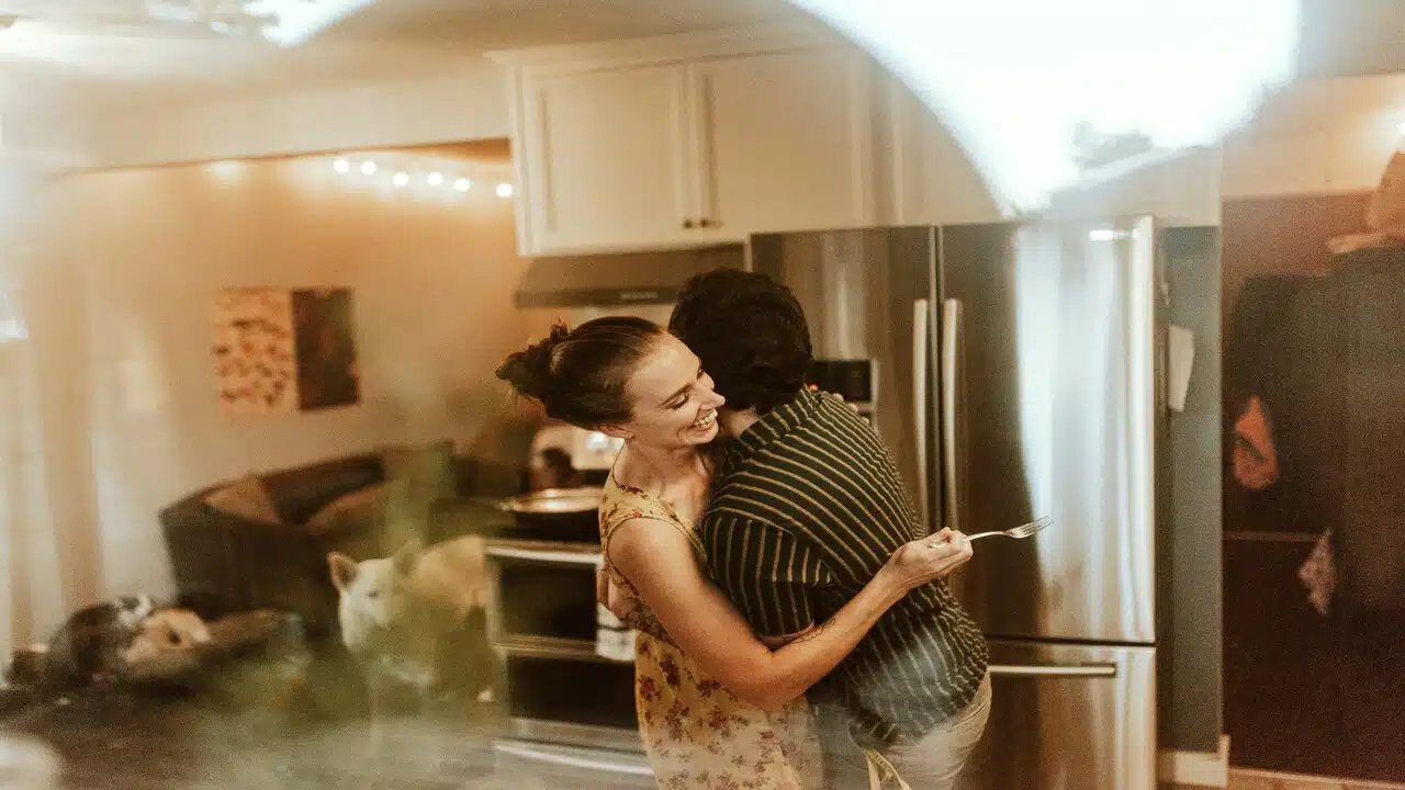 A couple hugging in the kitchen