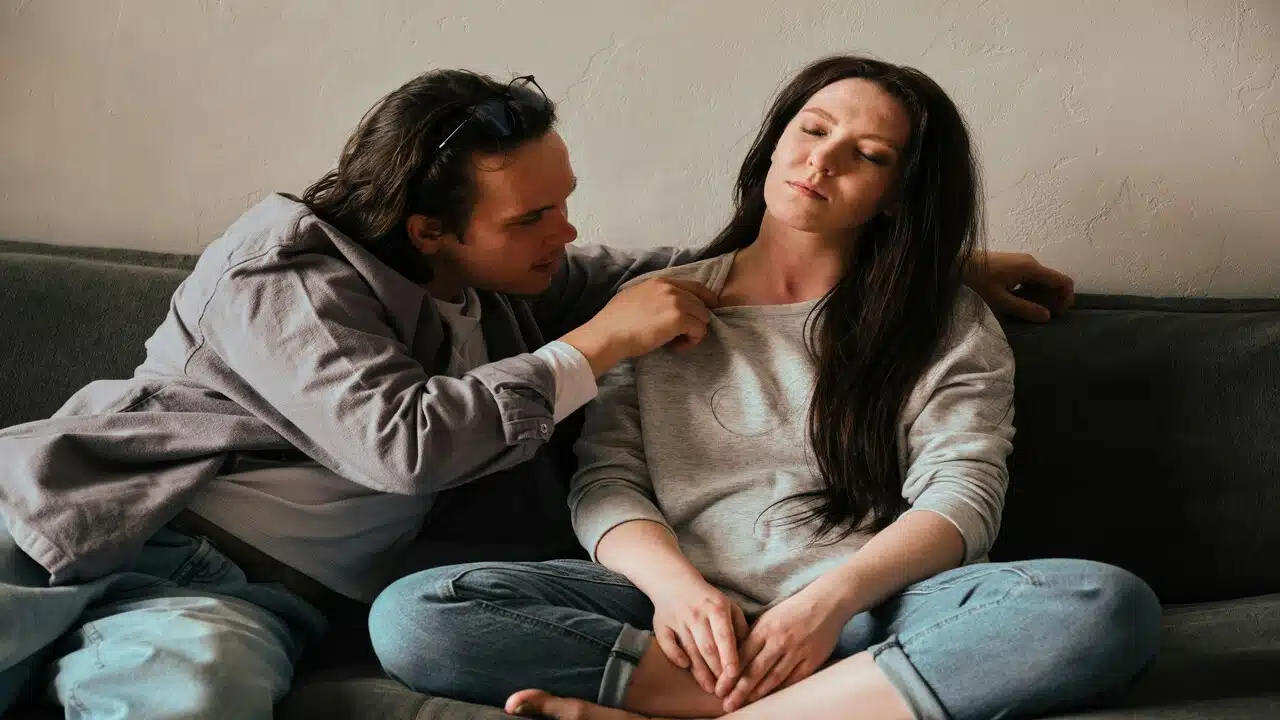 A woman avoiding her husband’s kiss
