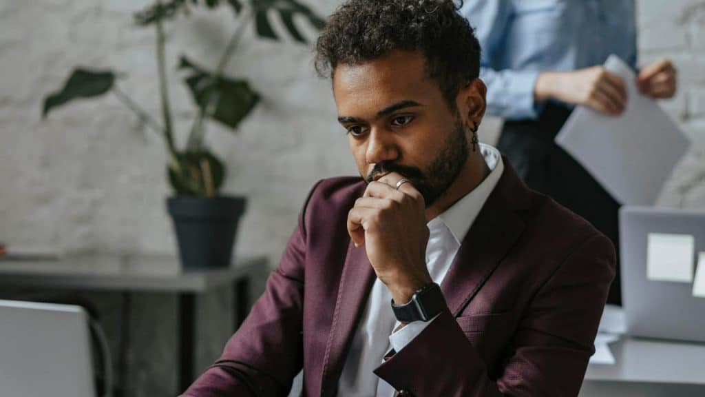 A thoughtful man in a suit working
